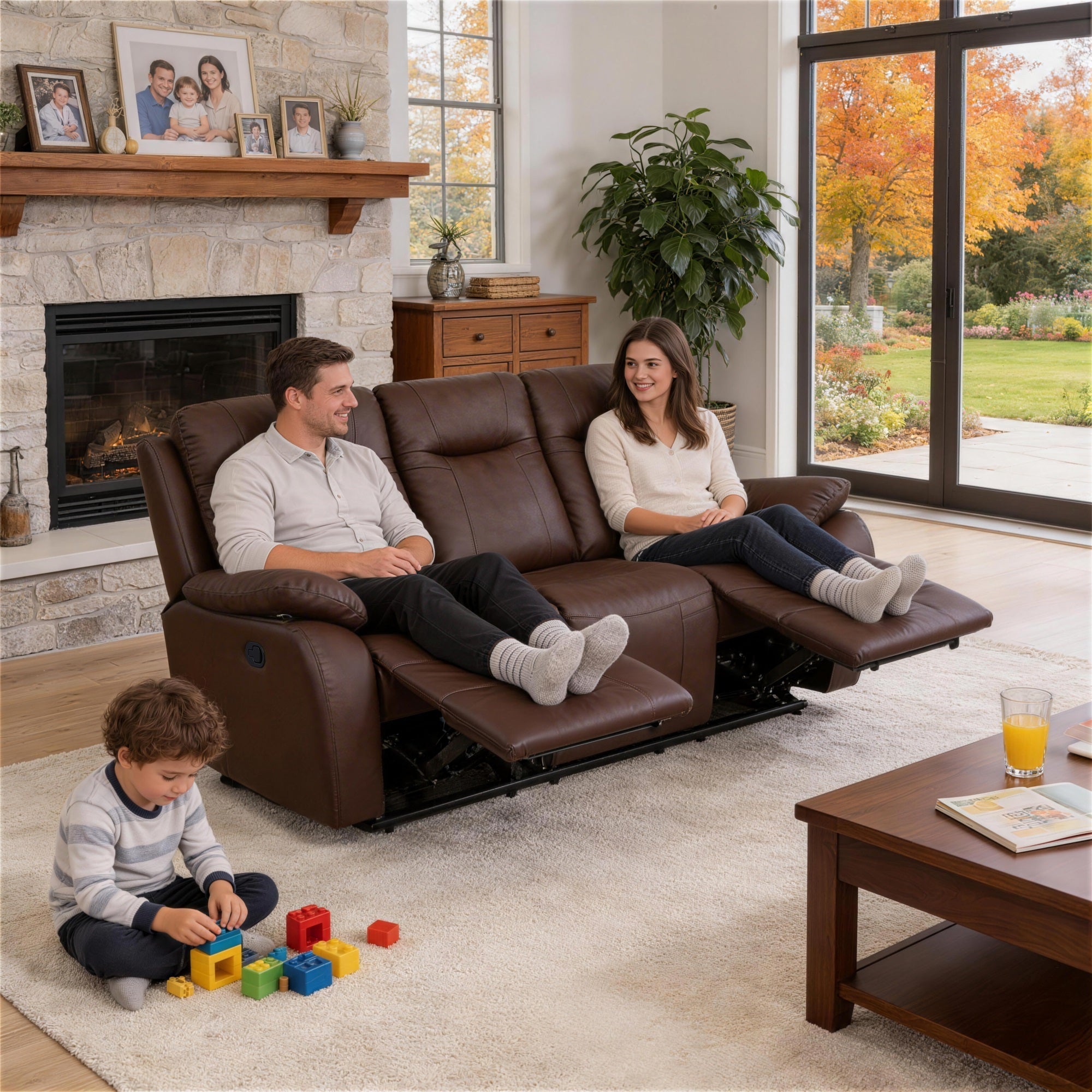 A man and a woman are sitting comfortably on the Evian Manual Recliner sofa, taking a rest.The child is playing with toys.